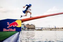 Red Bull will have people running across a greased pole — and falling into the Delaware River — on Saturday